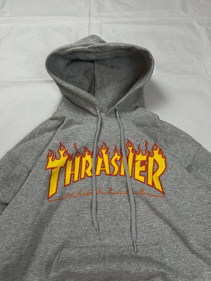 Thrasher grey hoodie with yellow and red flaming logo, kangaroo pocket, drawstring hood.