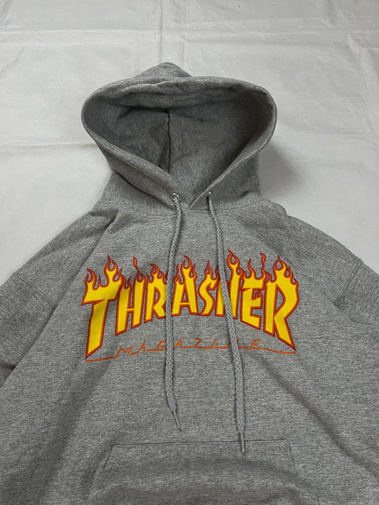 Thrasher grey hoodie with yellow and red flaming logo, kangaroo pocket, drawstring hood.