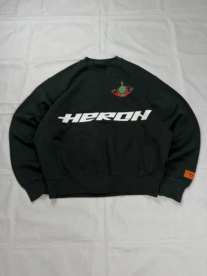 Heron Preston black graphic crewneck sweatshirt with white 'HERON' text and orange label patch.