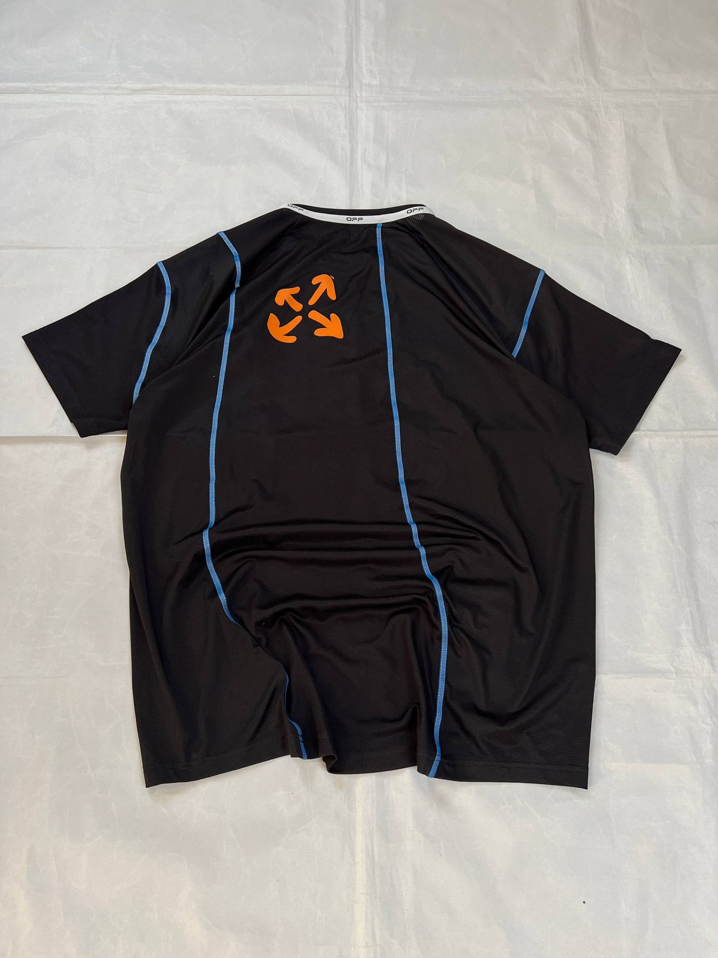 OFF black technical t-shirt with blue stitching and orange logo accents.