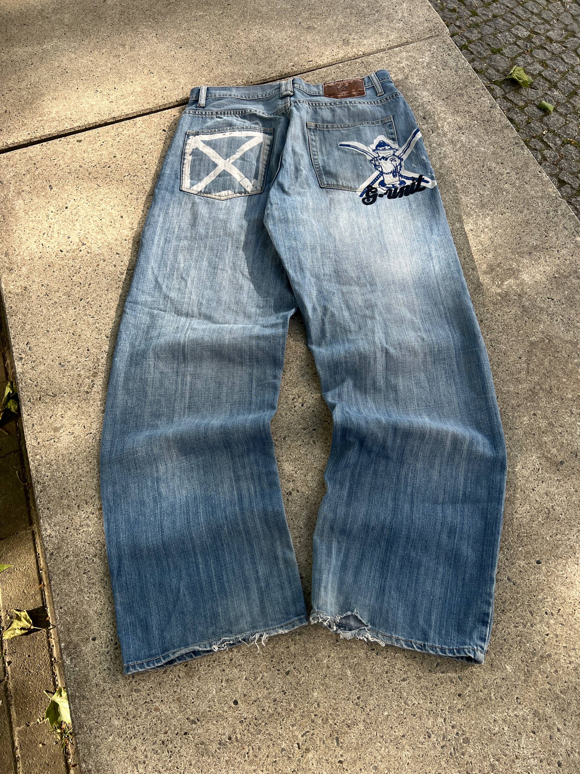 G-Unit light blue denim jeans with unique back pocket designs and leather brand patch.