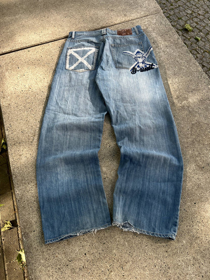 G-Unit light blue denim jeans with unique back pocket designs and leather brand patch.