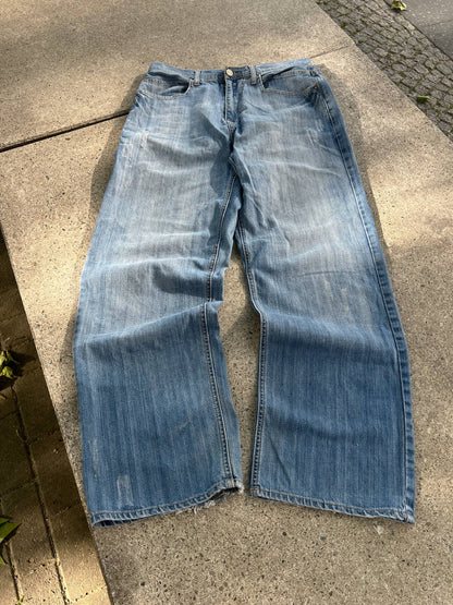 G-Unit light blue denim jeans with unique back pocket designs and leather brand patch.