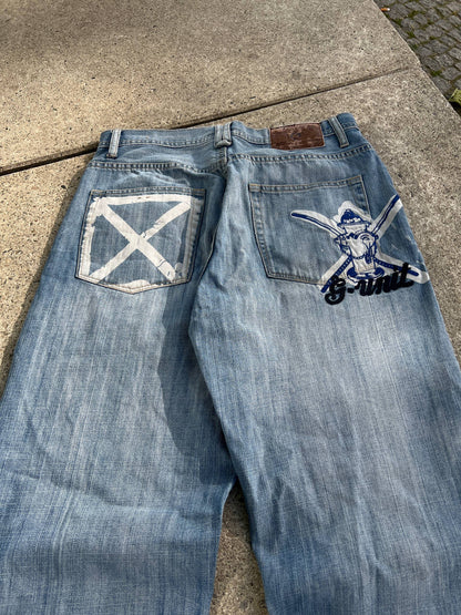 G-Unit light blue denim jeans with unique back pocket designs and leather brand patch.