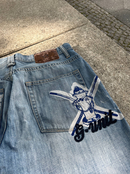 G-Unit light blue denim jeans with unique back pocket designs and leather brand patch.