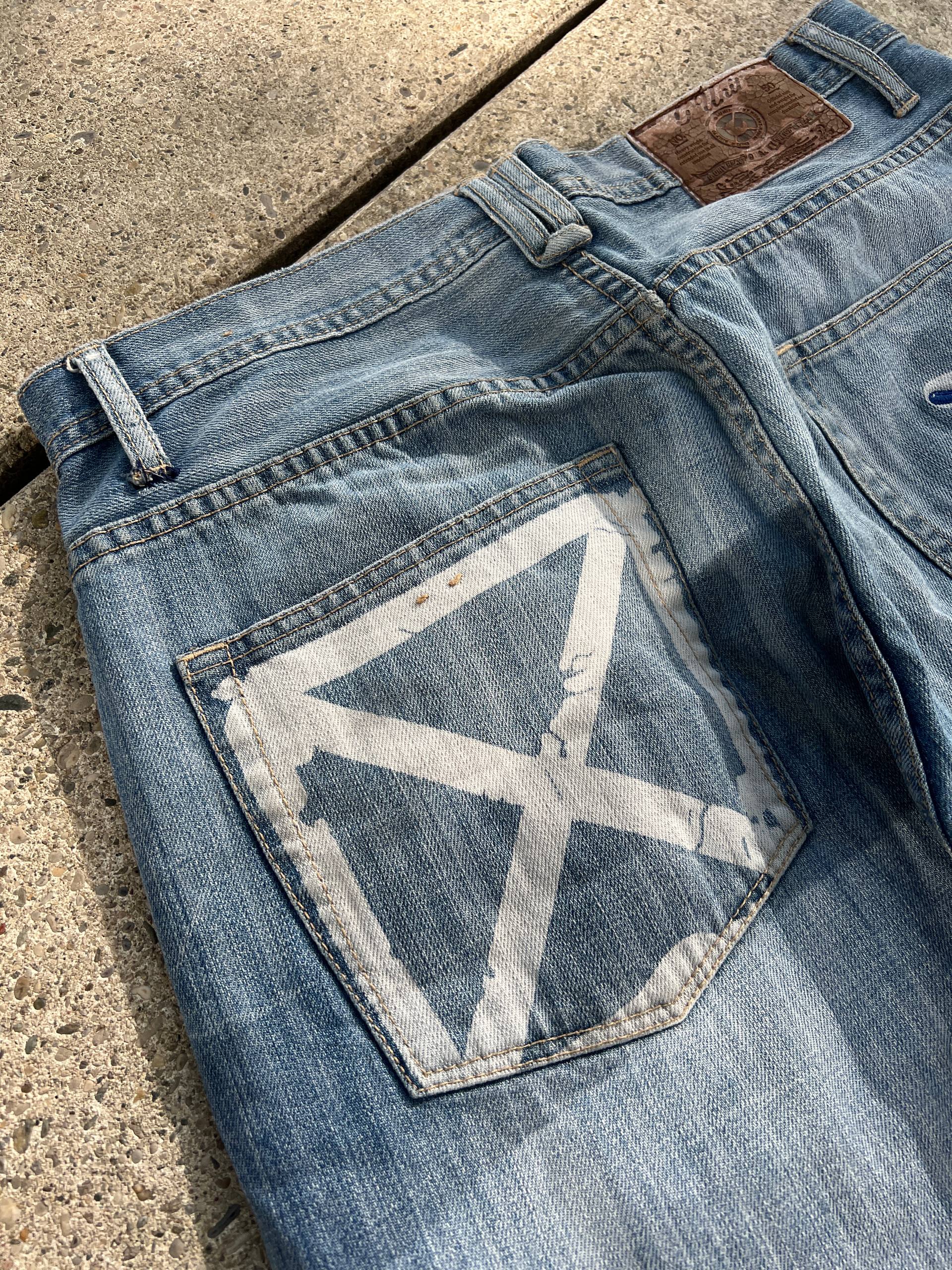 G-Unit light blue denim jeans with unique back pocket designs and leather brand patch.