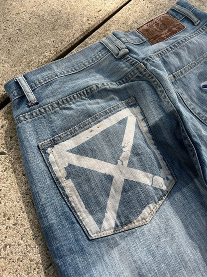 G-Unit light blue denim jeans with unique back pocket designs and leather brand patch.