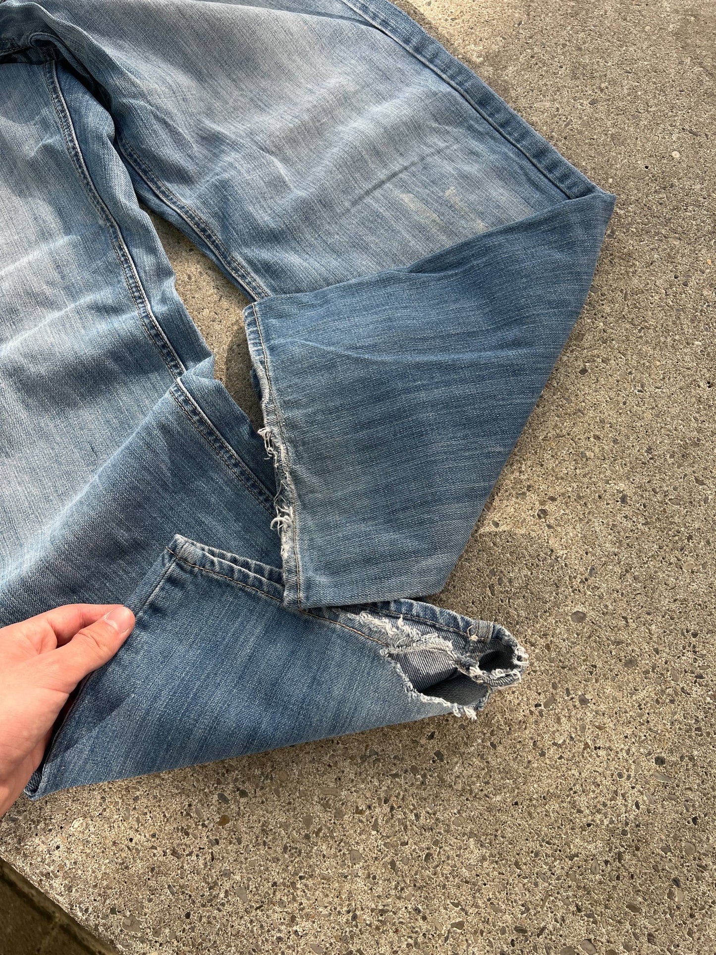 G-Unit light blue denim jeans with unique back pocket designs and leather brand patch.