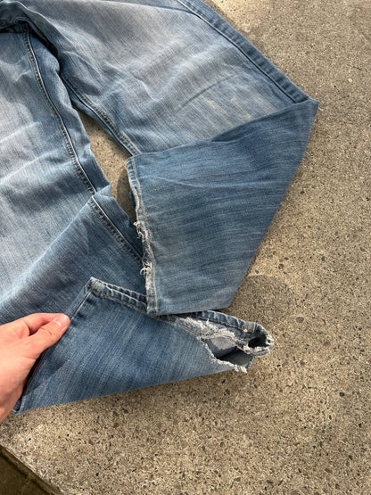 G-Unit light blue denim jeans with unique back pocket designs and leather brand patch.