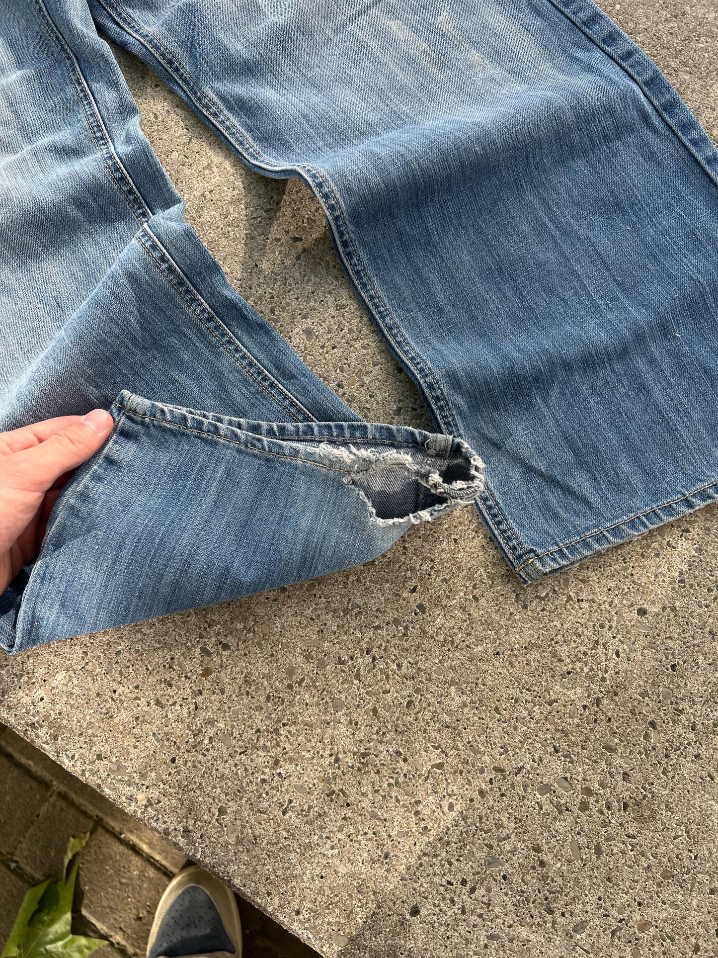 G-Unit light blue denim jeans with unique back pocket designs and leather brand patch.