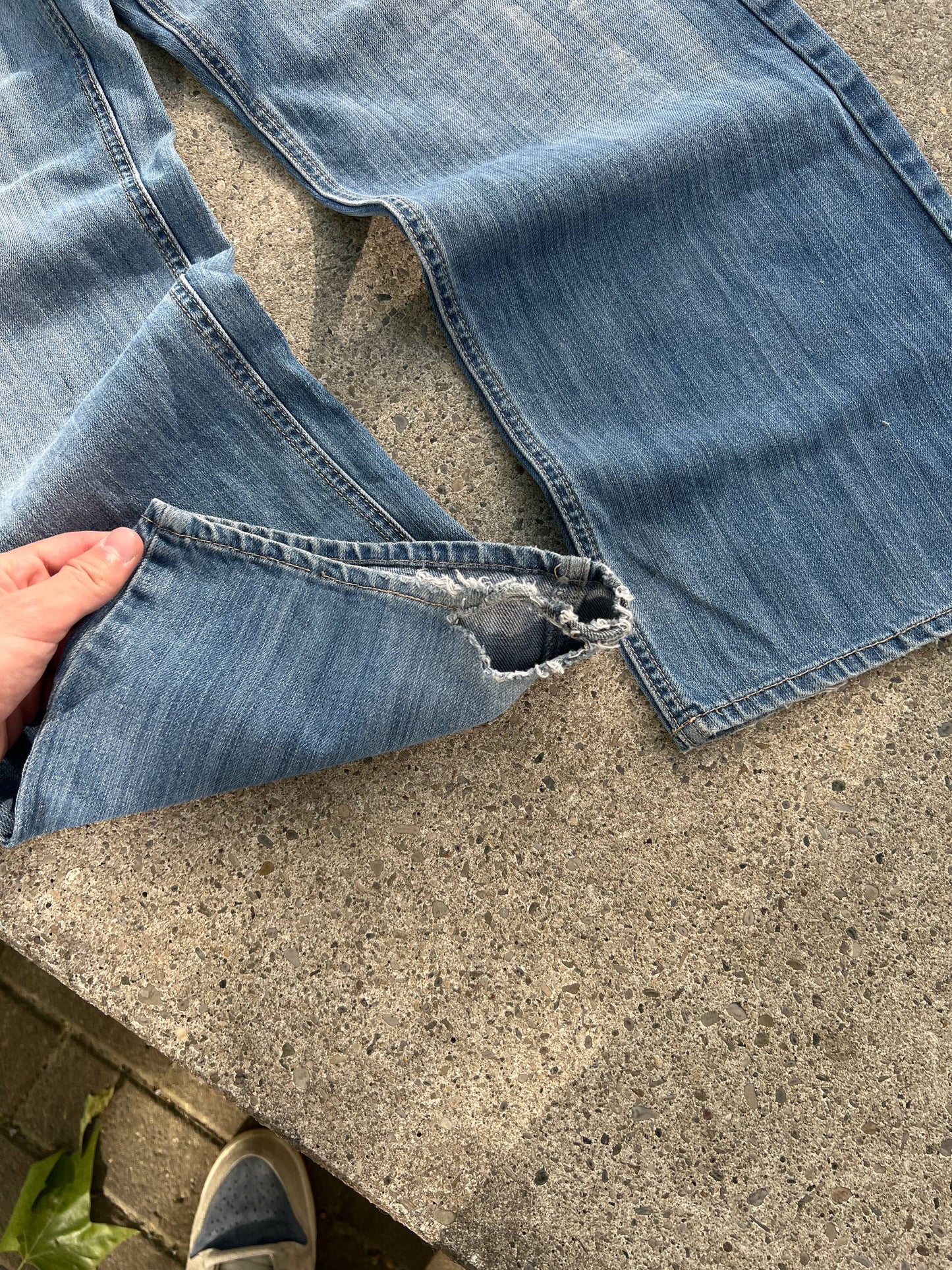 G-Unit light blue denim jeans with unique back pocket designs and leather brand patch.