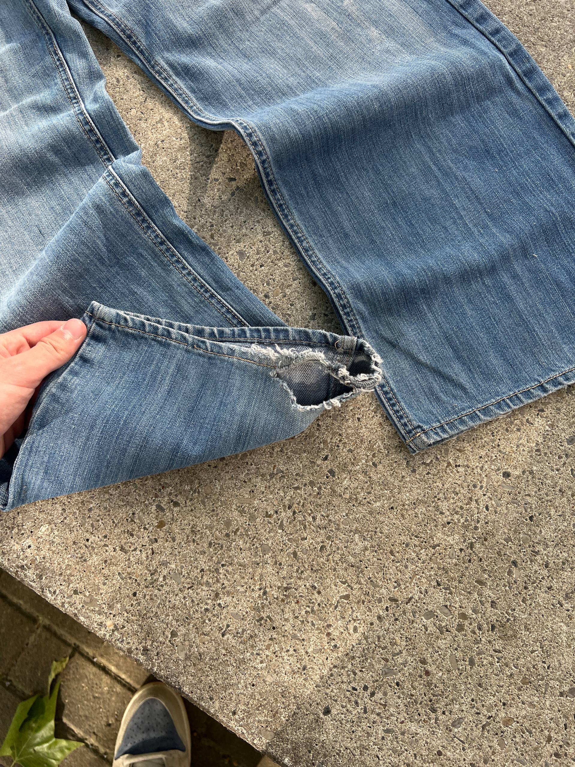 G-Unit light blue denim jeans with unique back pocket designs and leather brand patch.