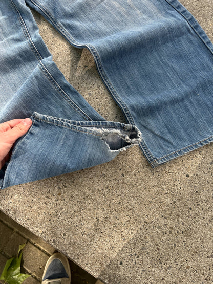G-Unit light blue denim jeans with unique back pocket designs and leather brand patch.