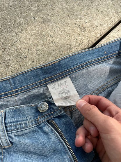 G-Unit light blue denim jeans with unique back pocket designs and leather brand patch.