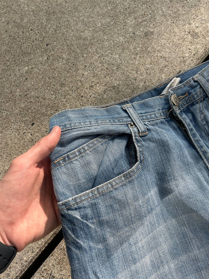 G-Unit light blue denim jeans with unique back pocket designs and leather brand patch.