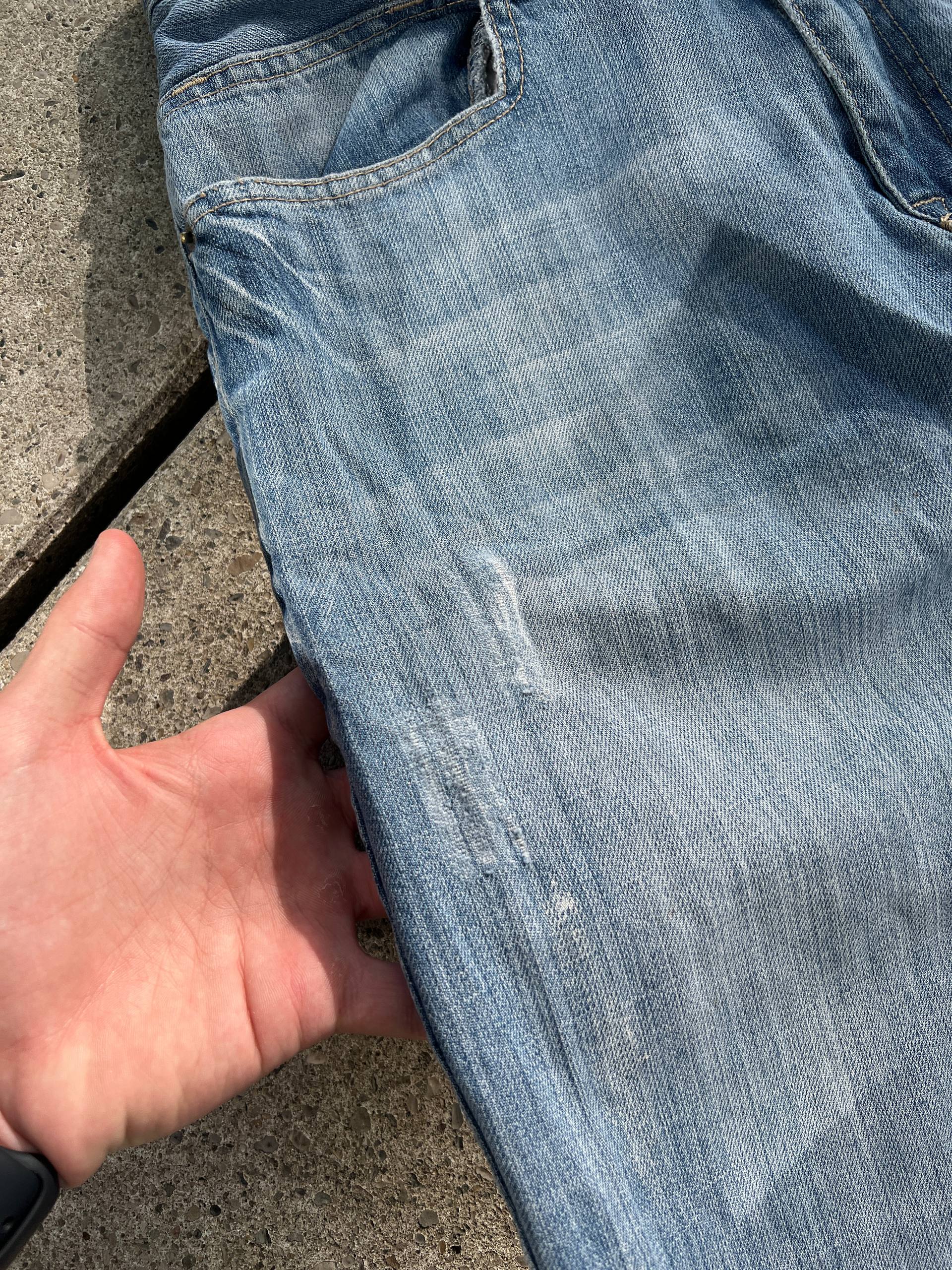 G-Unit light blue denim jeans with unique back pocket designs and leather brand patch.
