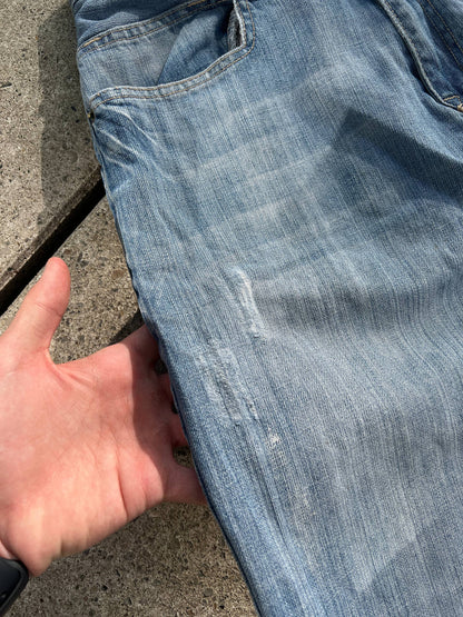 G-Unit light blue denim jeans with unique back pocket designs and leather brand patch.