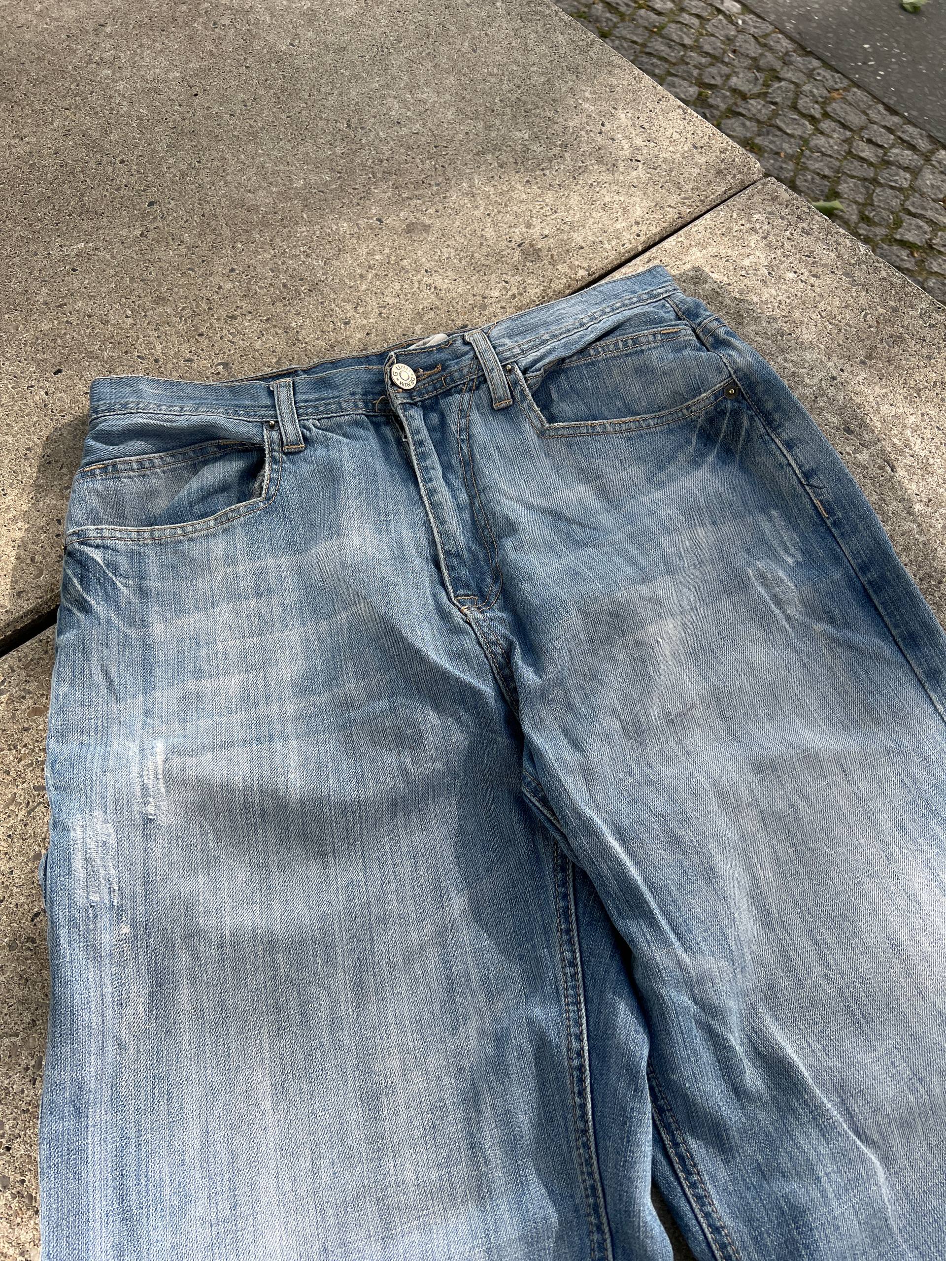 G-Unit light blue denim jeans with unique back pocket designs and leather brand patch.