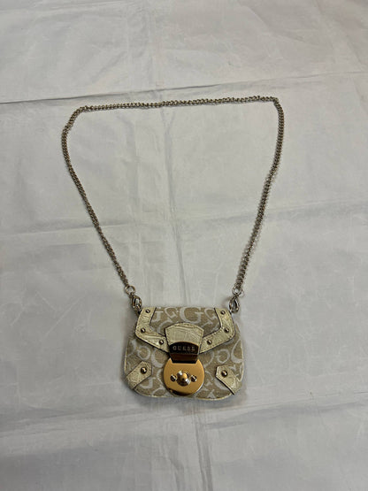 Guess beige mini crossbody bag with white signature print and gold-tone chain strap.