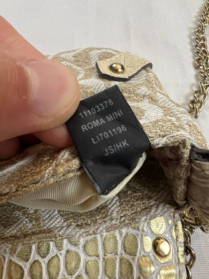 Guess beige mini crossbody bag with white signature print and gold-tone chain strap.