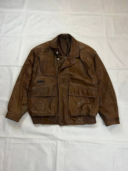 Bomber brown leather men's vintage bomber jacket with elasticized waist and flap pockets.