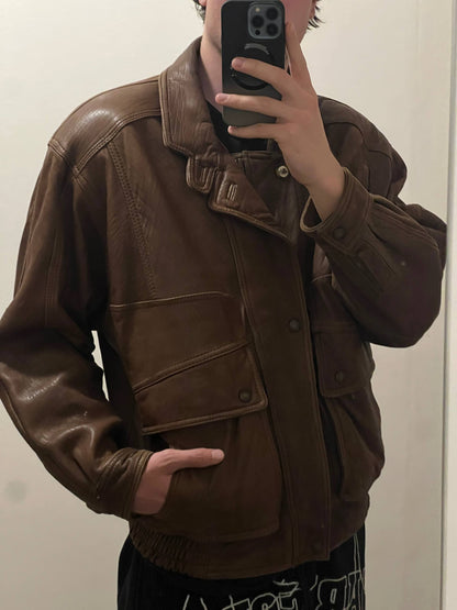 Bomber brown leather men's vintage bomber jacket with elasticized waist and flap pockets.