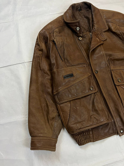 Bomber brown leather men's vintage bomber jacket with elasticized waist and flap pockets.