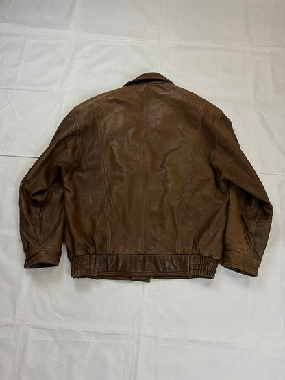 Bomber brown leather men's vintage bomber jacket with elasticized waist and flap pockets.