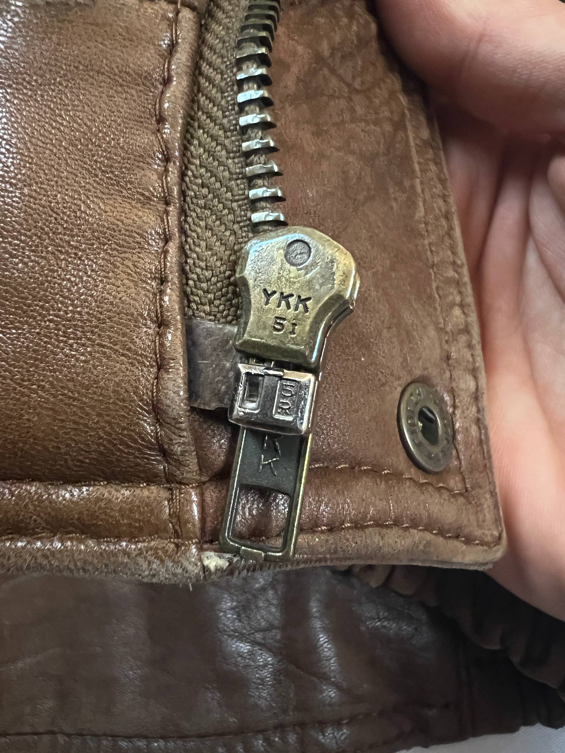 Bomber brown leather men's vintage bomber jacket with elasticized waist and flap pockets.