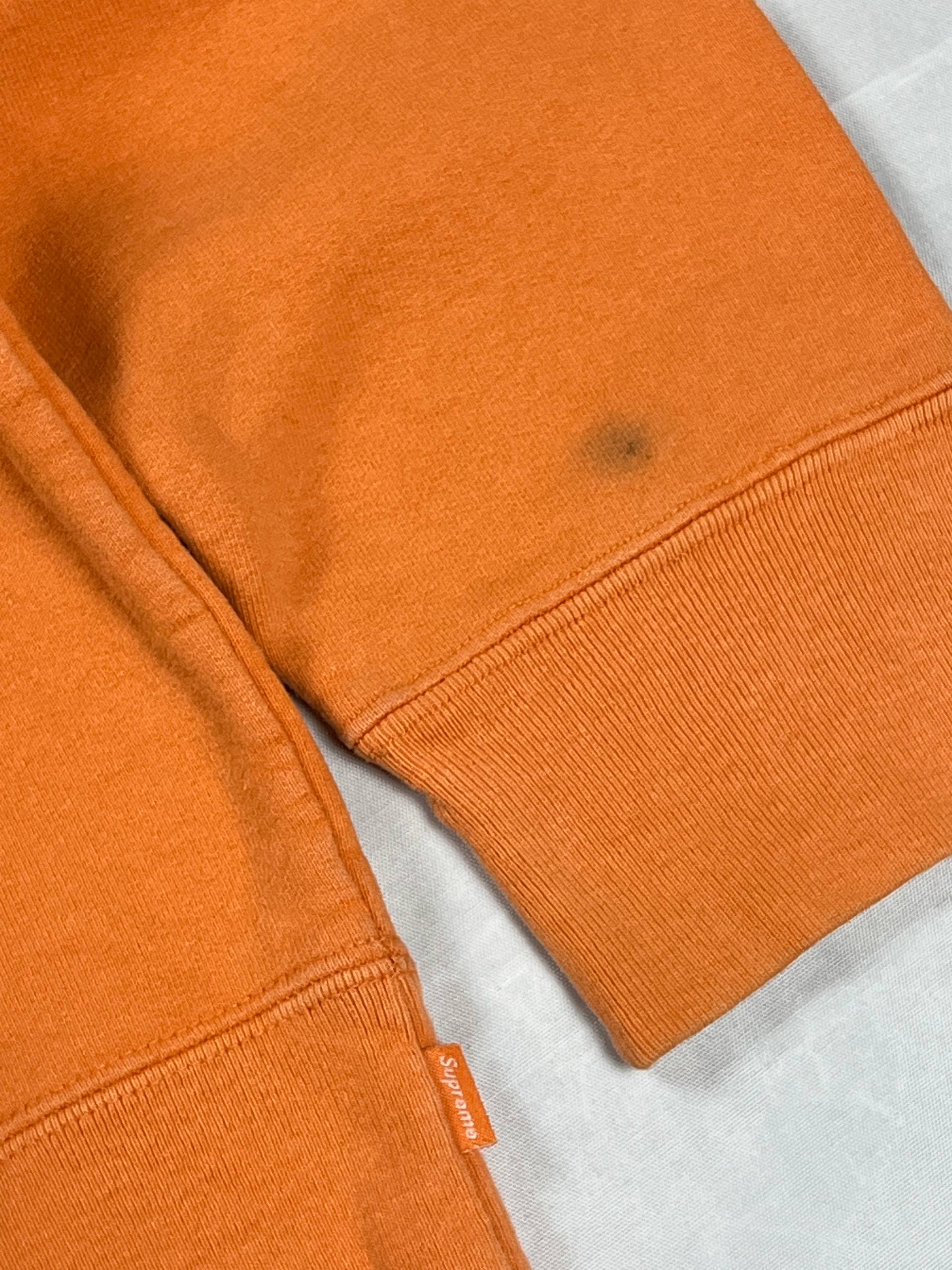 Supreme orange crewneck sweatshirt large embroidered logo on chest, soft cotton material.